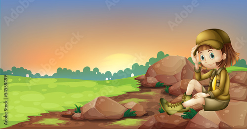 A female explorer relaxing above a rock