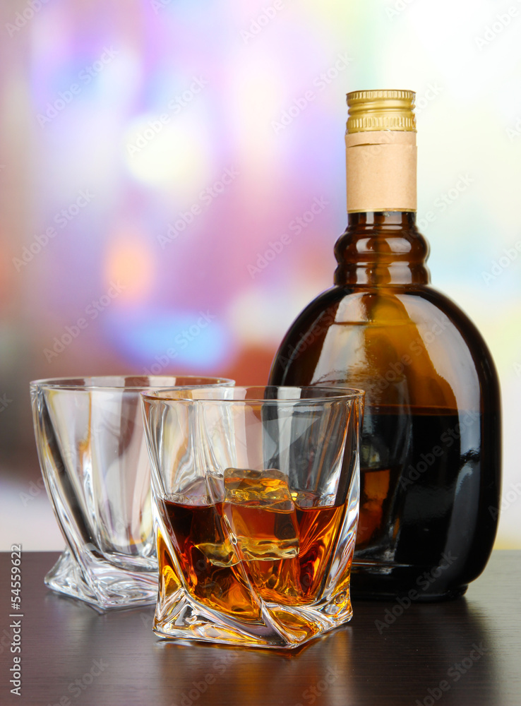 Glass of liquor with bottle, on dark background Glass of liquor with bottle, on dark background