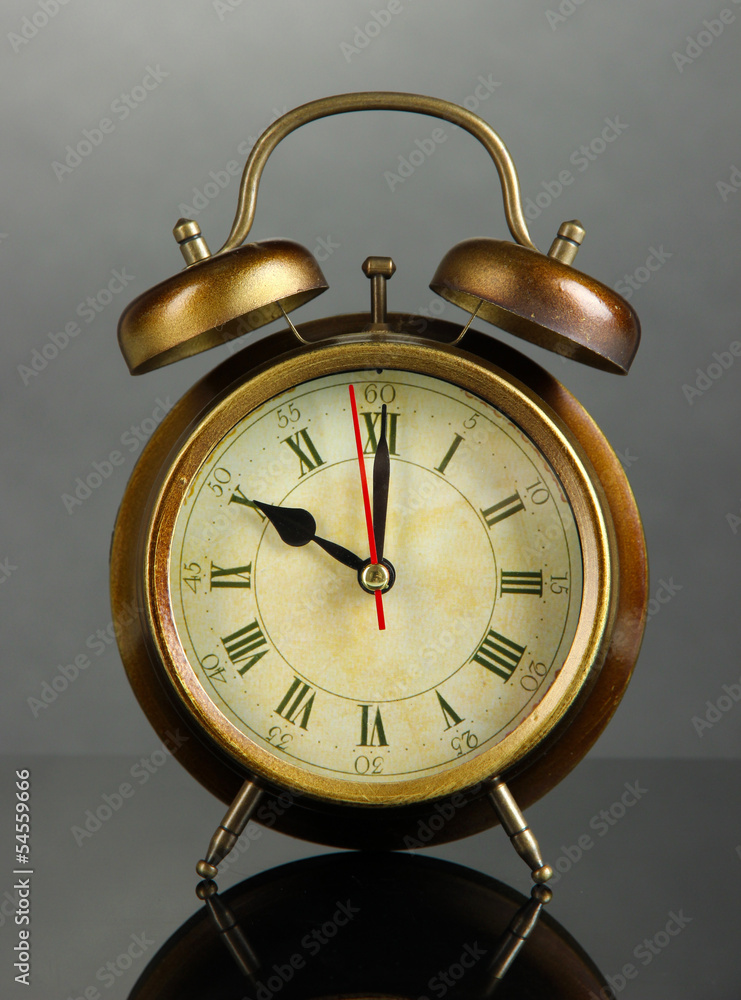 Old alarm clock on gray background Old alarm clock on gray background