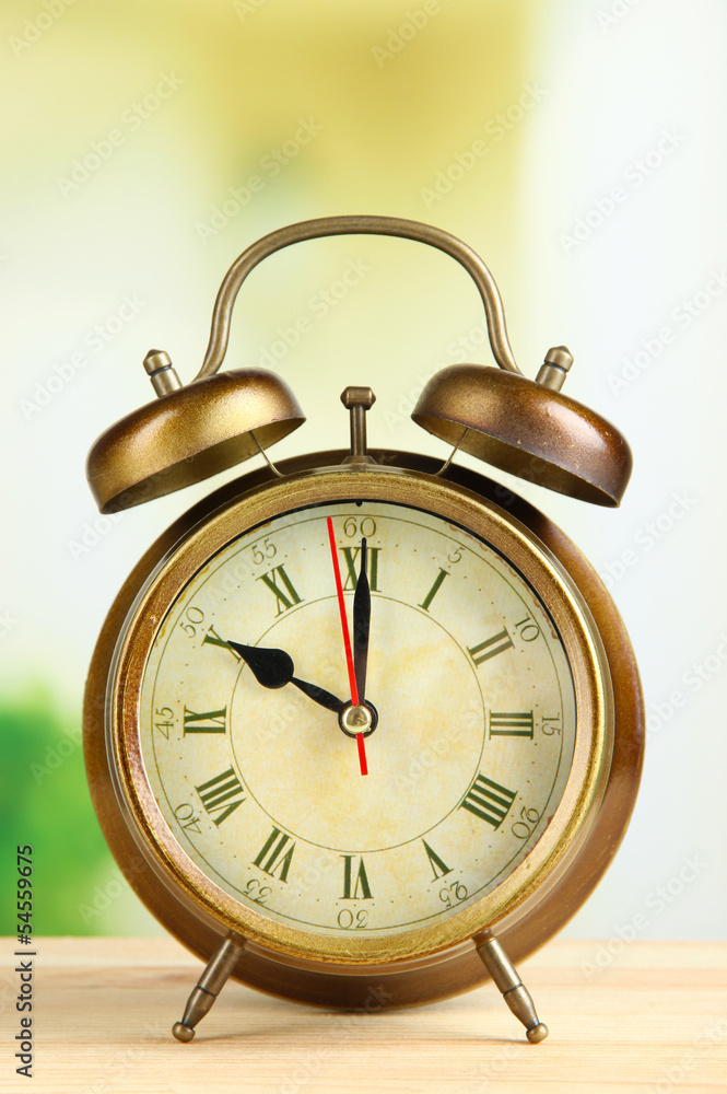 Old alarm clock on bright background Old alarm clock on bright background