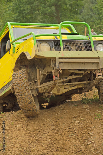 Yellow off-road car leaves steep slope