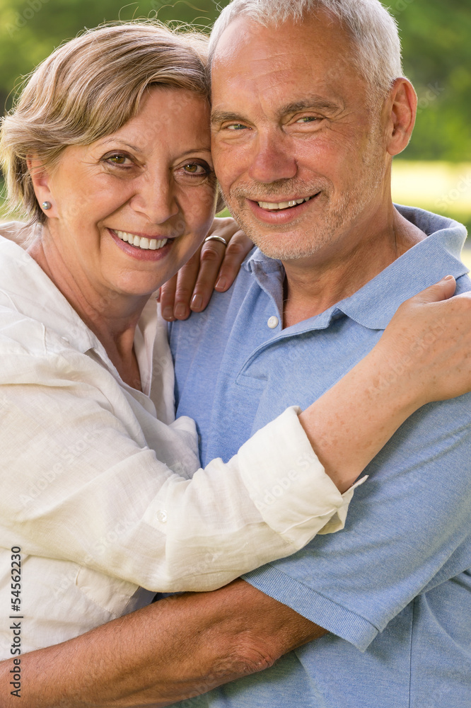 Amorous senior couple embracing in park