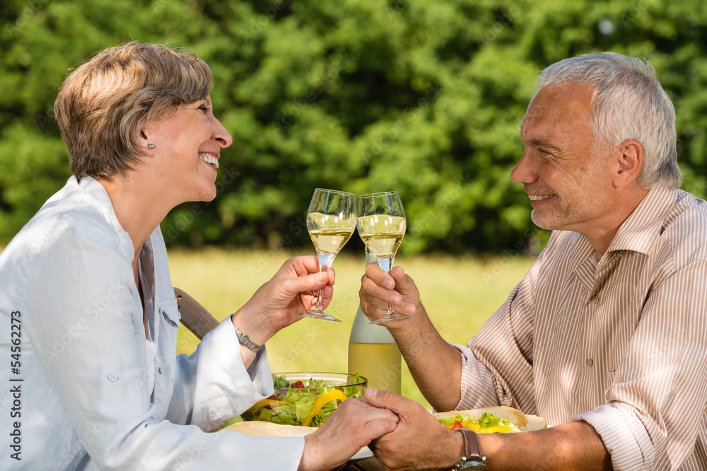 Senior couple drinking wine in the garden