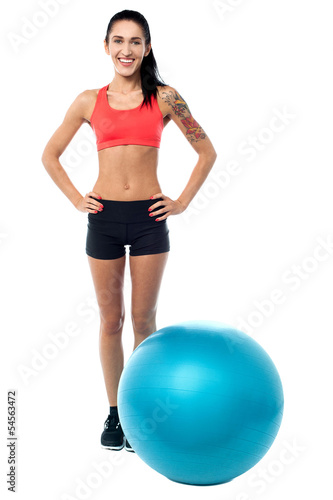 Young woman in gym wear with exercise ball