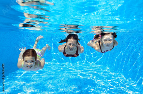 Happy family swim underwater in pool and having fun