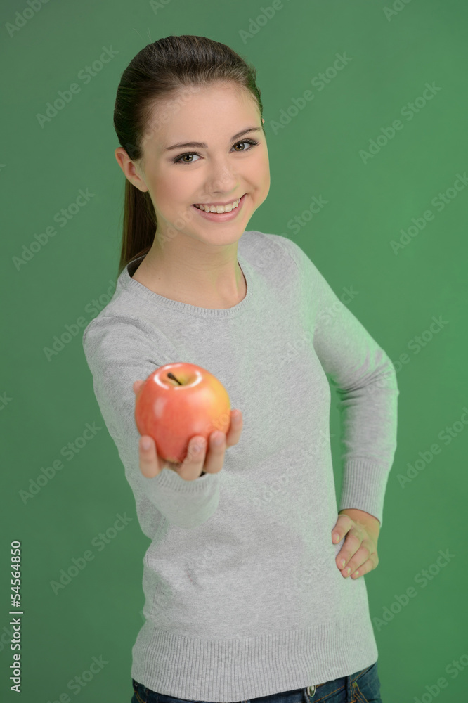 Teenage girl with apple. Happy teenage girl holding an apple whi Teenage girl with apple. Happy teenage girl holding an apple whi