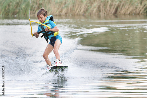 young boy wakeboarding