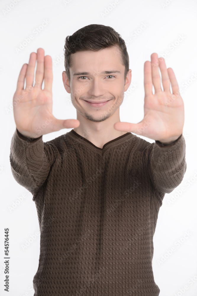 Stop gesture. Cheerful young men showing a stop sign by his hand Stop gesture. Cheerful young men showing a stop sign by his hand