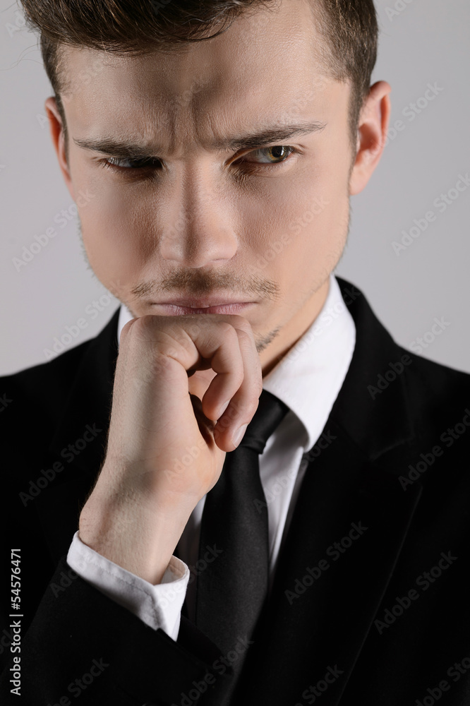 Thoughtful businessman. Portrait of businessman holding hand on Thoughtful businessman. Portrait of businessman holding hand on