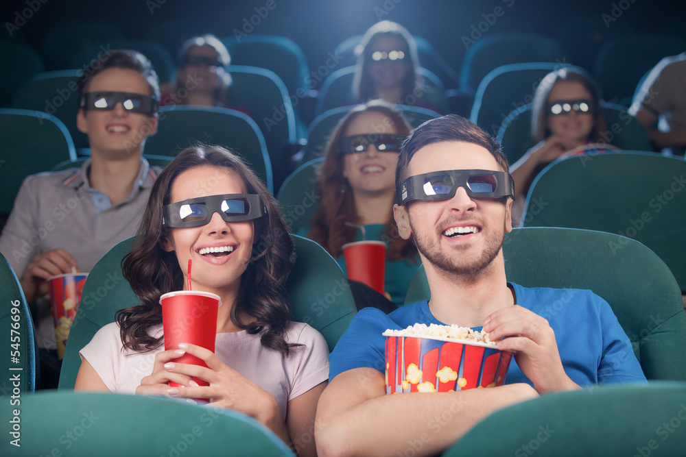 People at the cinema. Cheerful people in three-dimensional glass