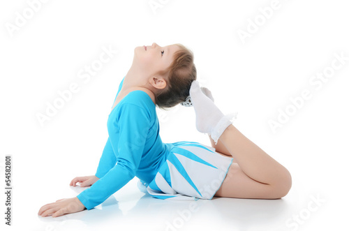 Little girl the gymnast does exercise