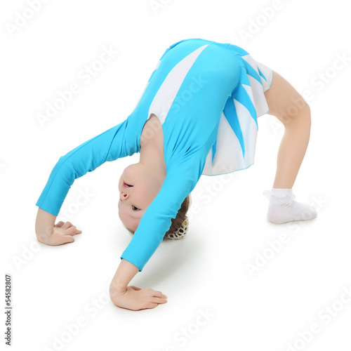 Little girl the gymnast does exercise