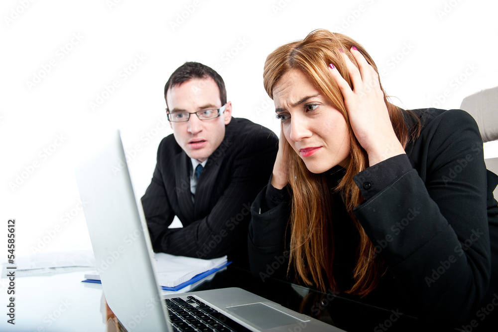 Two colleagues working together on a laptop computer Two colleagues working together on a laptop computer