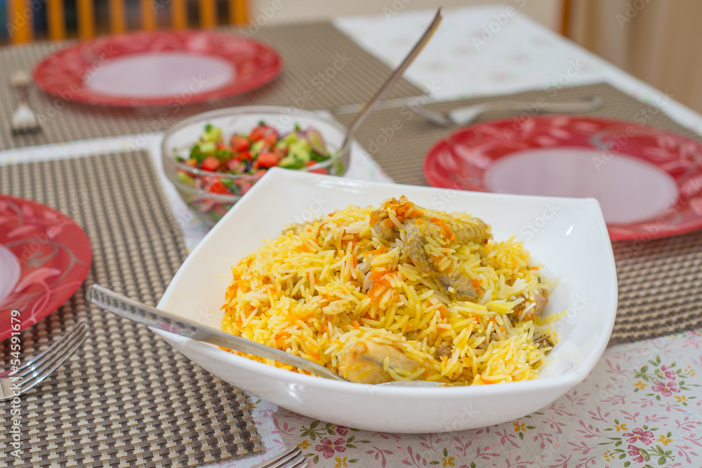 rice with chicken on a dining table rice with chicken on a dining table