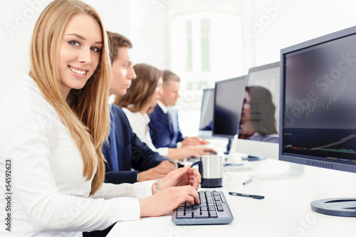 lächelnde junge Frau bei der Teamarbeit am Computer