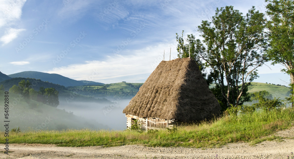 Old house in the mountains in the sunrise Old house in the mountains in the sunrise