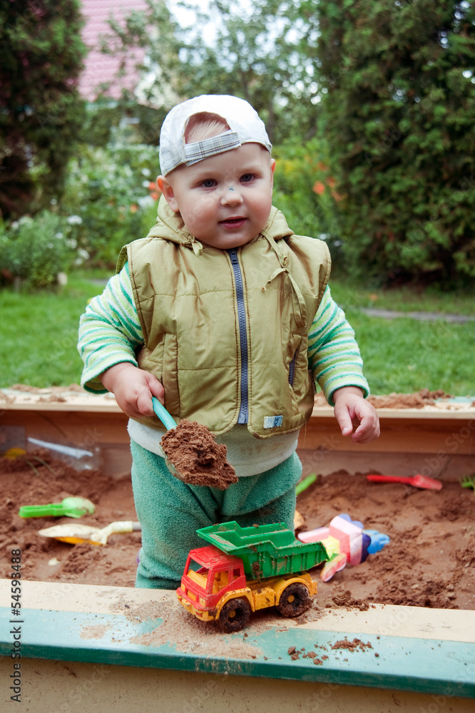 working boy playing in a sandbox working boy playing in a sandbox