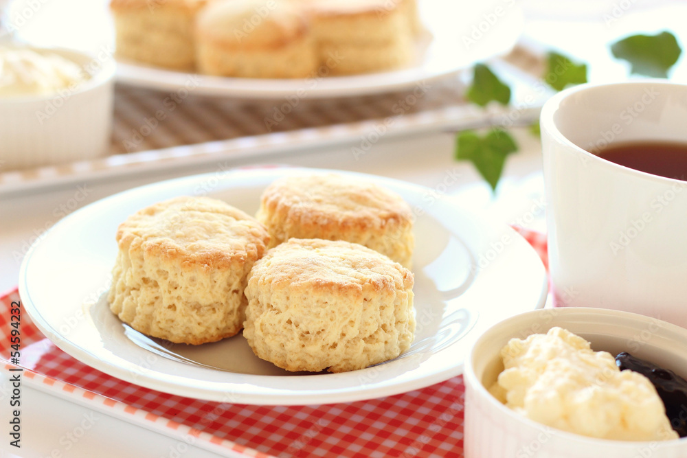 Home-baked scones with clotted cream, blackcurrant jam and tea Home-baked scones with clotted cream, blackcurrant jam and tea