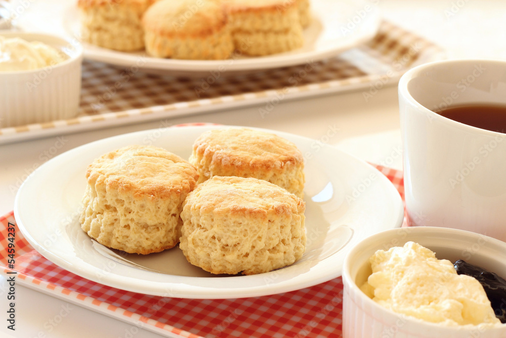 Home-baked scones with clotted cream, blackcurrant jam and tea Home-baked scones with clotted cream, blackcurrant jam and tea