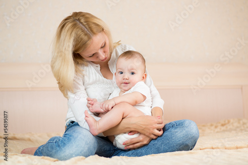 mother embracing baby boy indoors