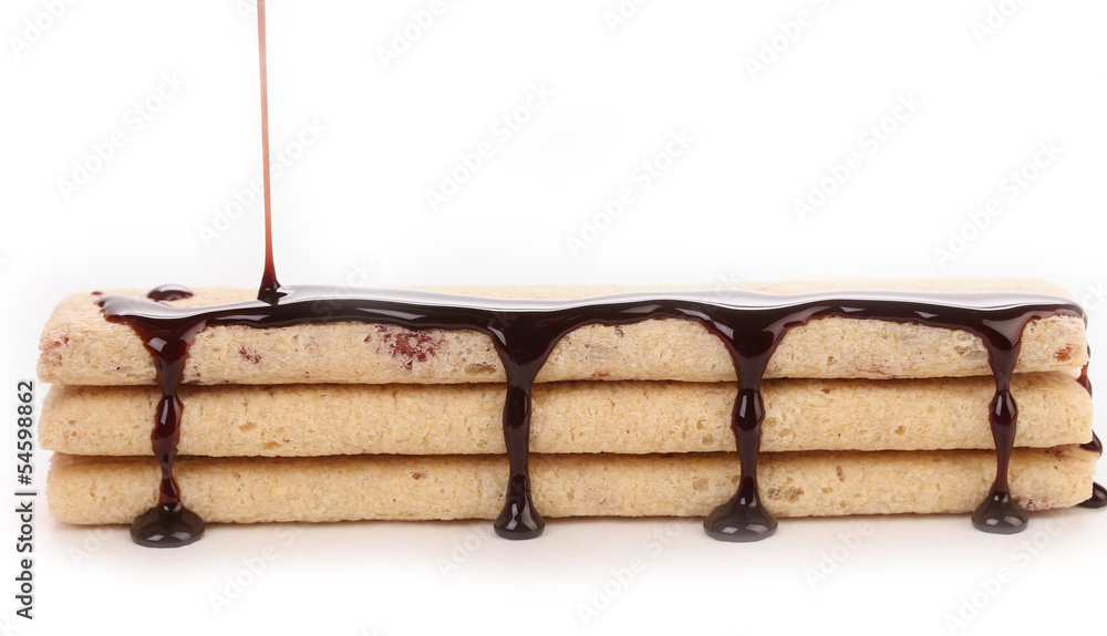 Fototapeta premium Stream chocolate on stics of biscuit.