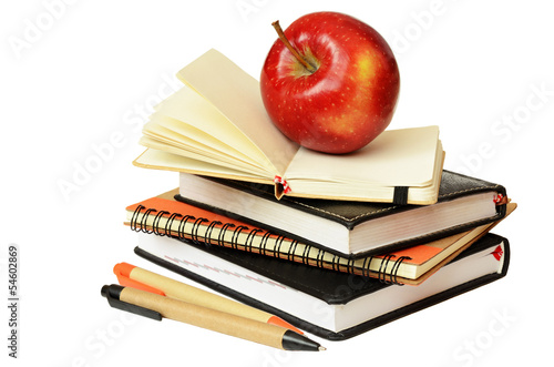 Notebooks, pens and apple