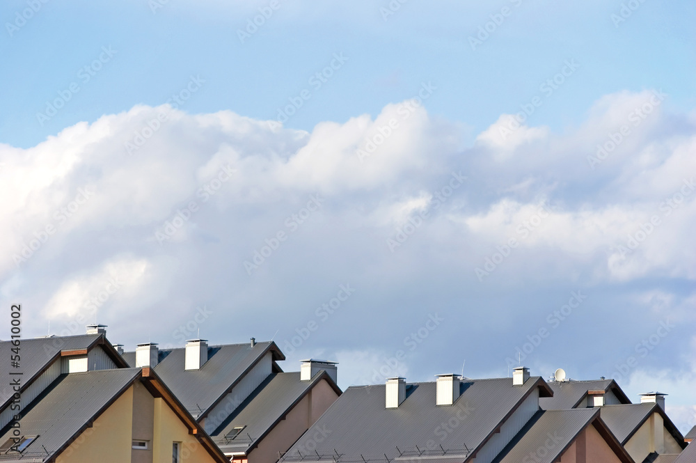 Fototapeta premium Row house roofs, condo rooftop panorama, summer sky
