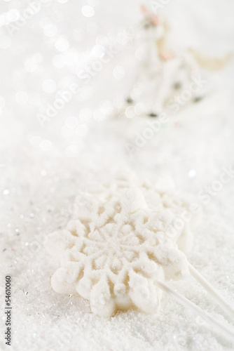 marshmallow lolly snowflake on white festive backround