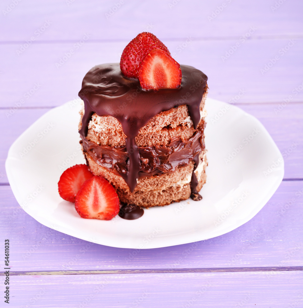 Chocolate cake with strawberry on wooden table close-up Chocolate cake with strawberry on wooden table close-up