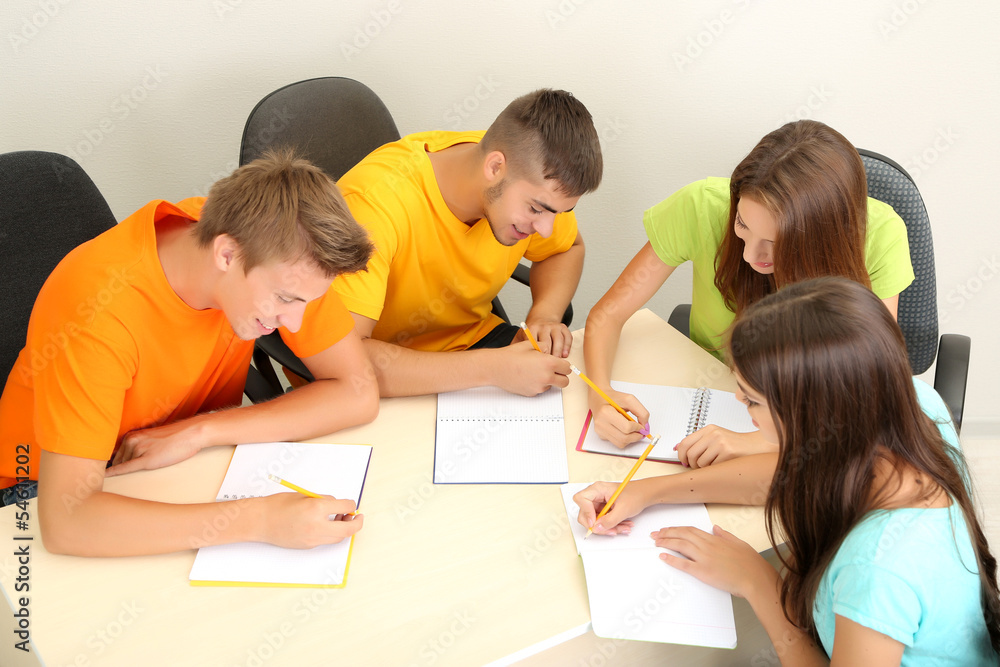 Group of young students sitting in the room Group of young students sitting in the room