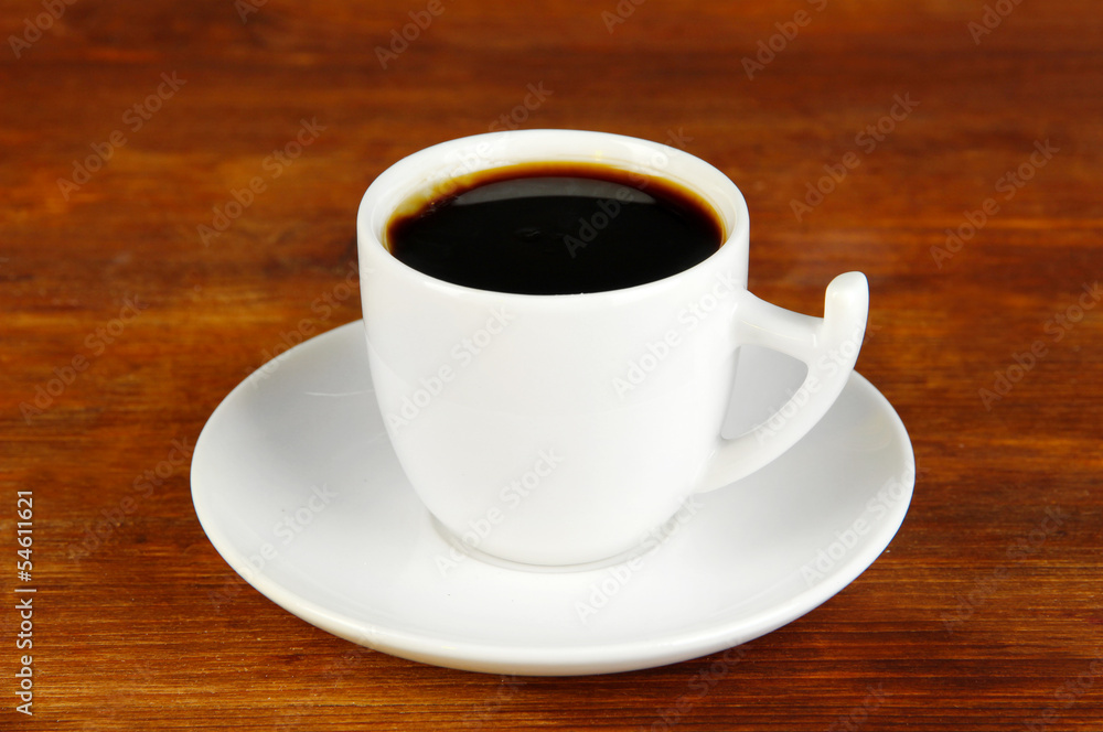 Cup of coffee on wooden table close-up