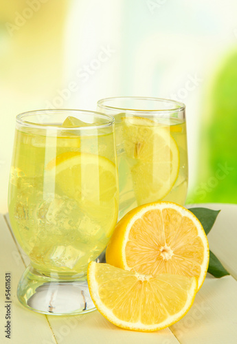 Delicious lemonade on table on light background