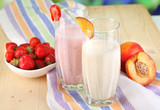 Delicious milk shakes with strawberries and peach