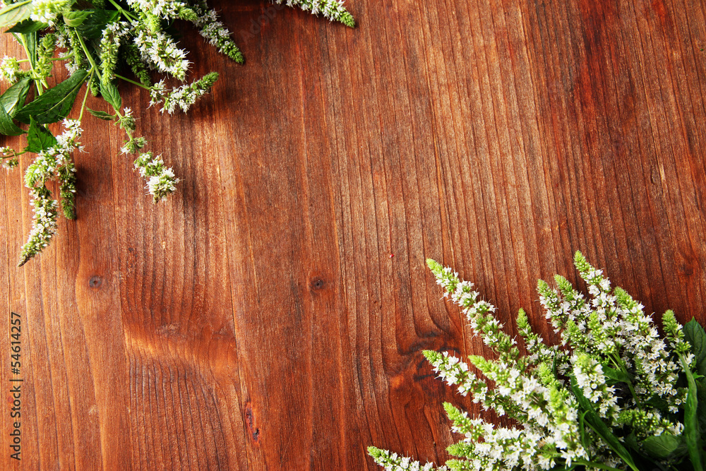 Fresh mint flowers on wooden background Fresh mint flowers on wooden background