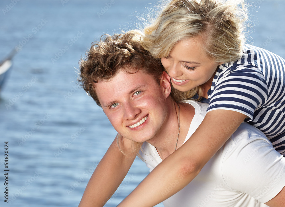 Young happy couple having fun on the beach. Young happy couple having fun on the beach.
