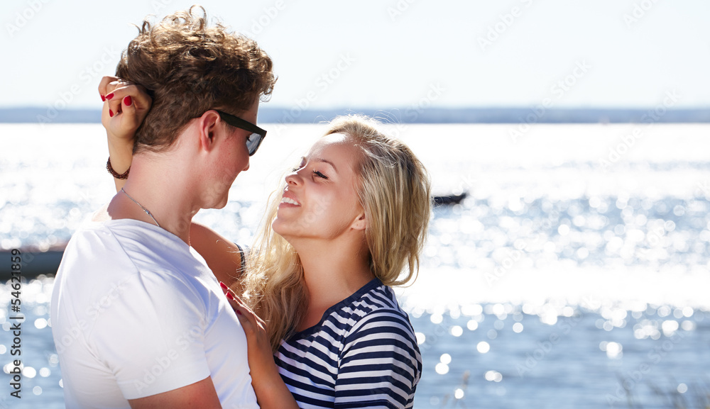 Portrait of a couple posing with the beach as background