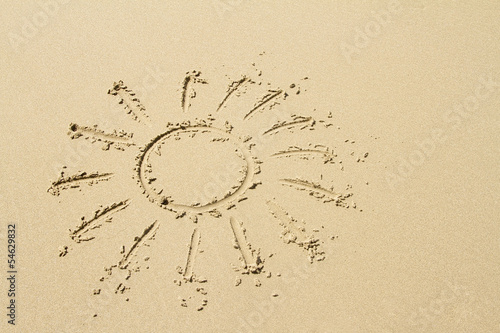 Sun drawn on golden sandy beach