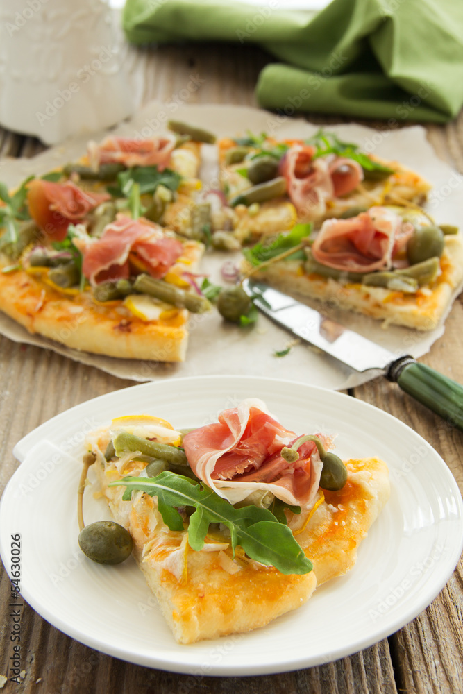 Pizza with arugula and prosciutto.