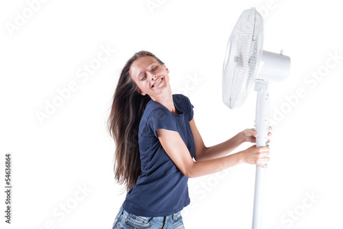 Young woman cooling herself under wind of cooler fan