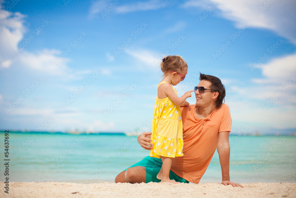Happy father and his adorable little daughter at beach Happy father and his adorable little daughter at beach