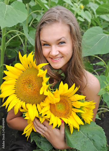 Young beautiful woman in a sunflower field