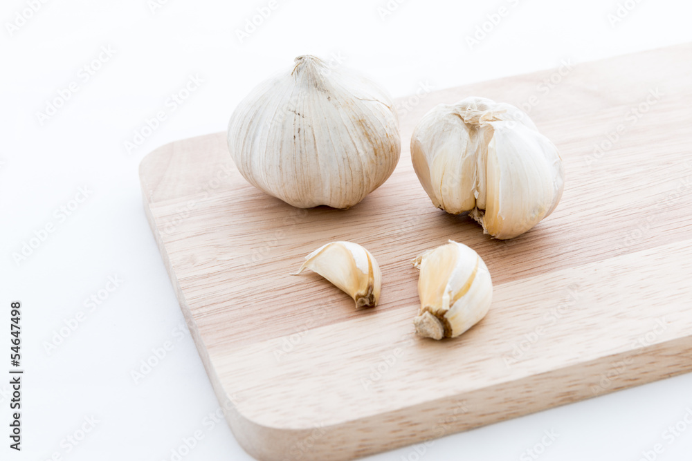 Garlic on Chopping block wood and isolated Garlic on Chopping block wood and isolated