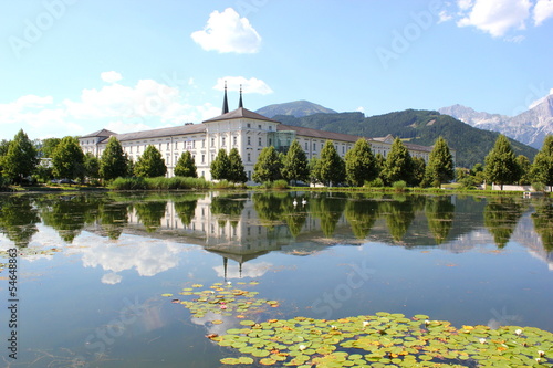 Stift Admont vor blauem Himmel spiegelt sich im Stiftssee photo