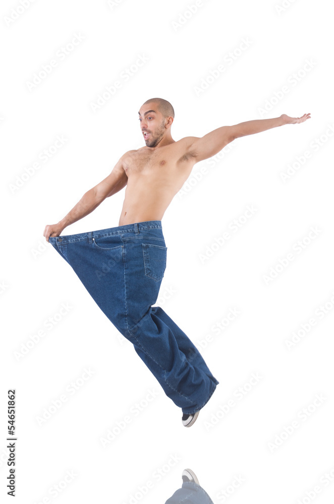 Man in dieting concept with oversized jeans Man in dieting concept with oversized jeans