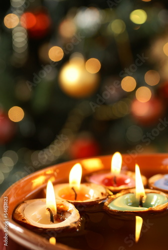 Candles in nutshells floating on water