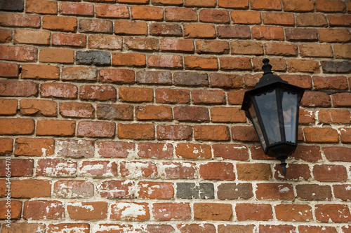 lamp on the old wall with red bricks