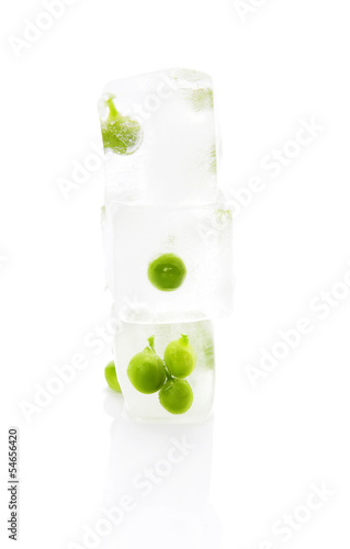 Green peas frozen in ice.