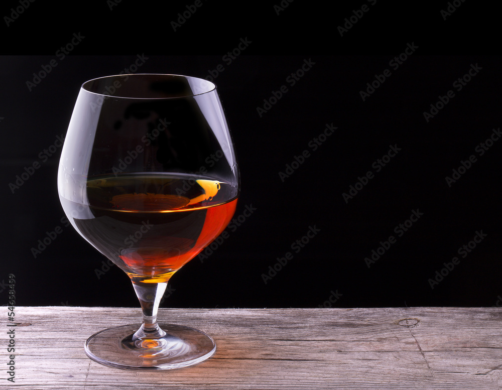 Cognac or brandy on a wooden table Cognac or brandy on a wooden table