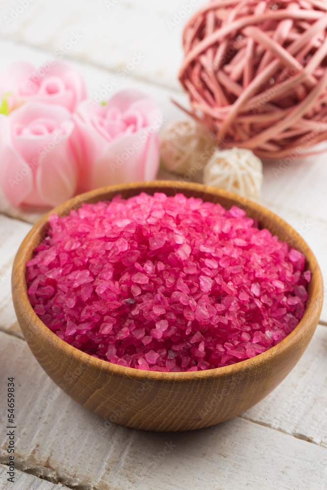 Sea salt in bowl on wooden background