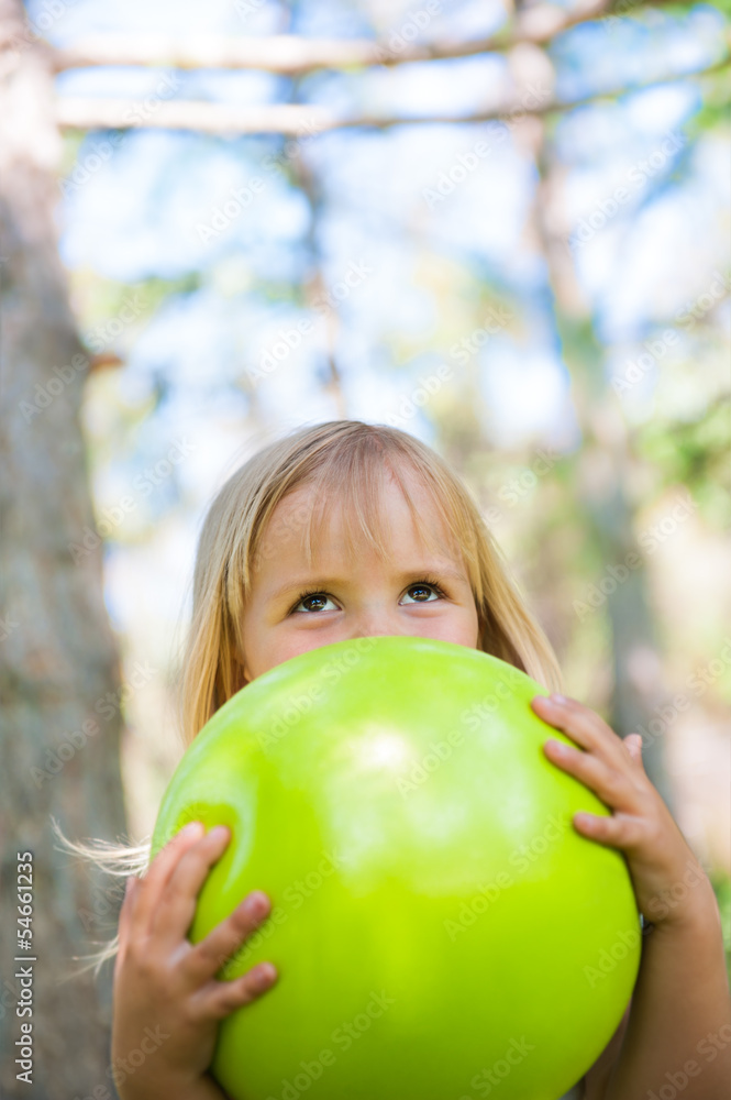 Little girl playing with green ball in the park Little girl playing with green ball in the park